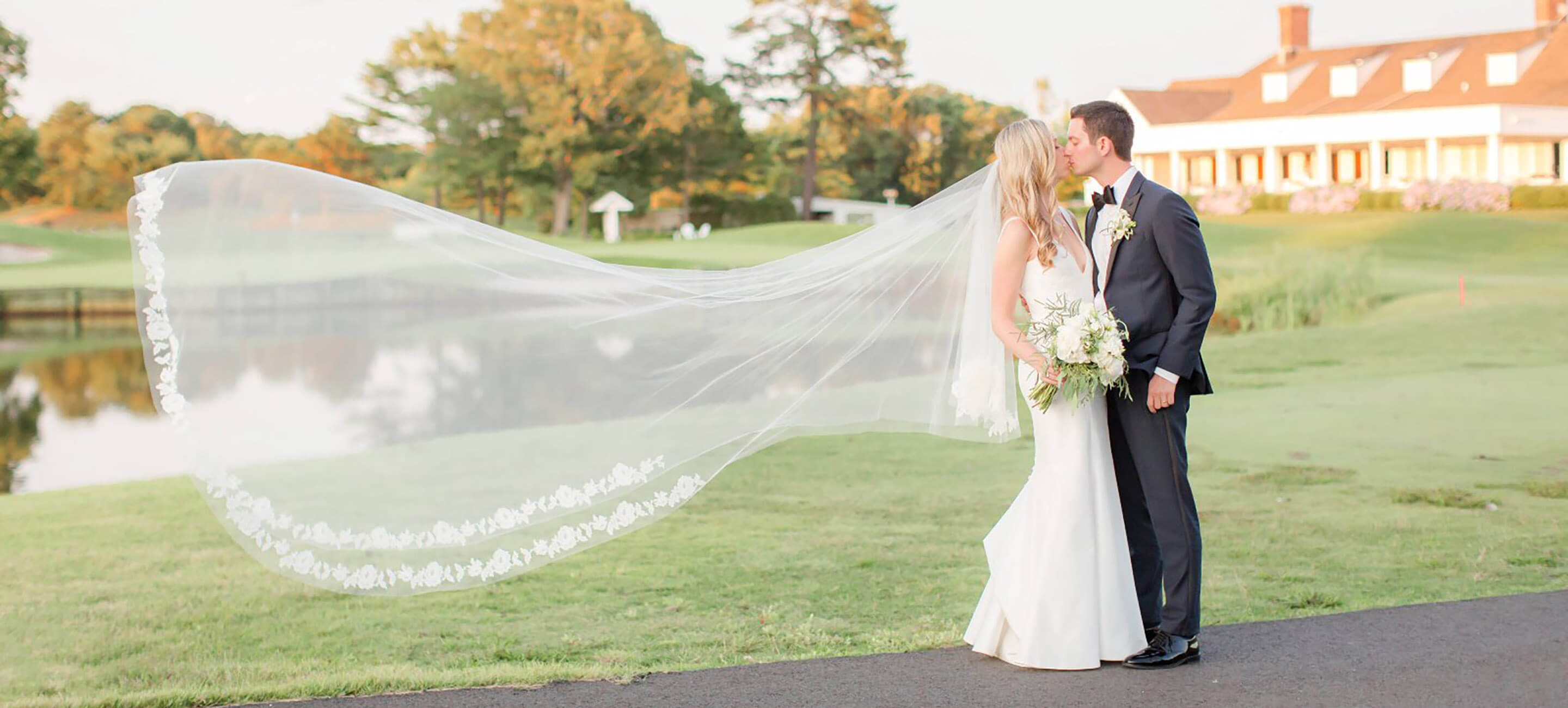 bride and groom on pathway by the green