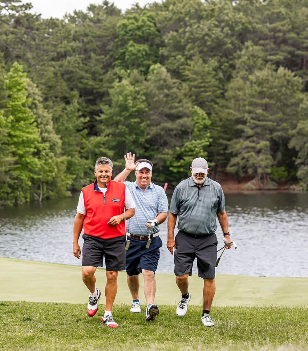 golfers waiving and smiling