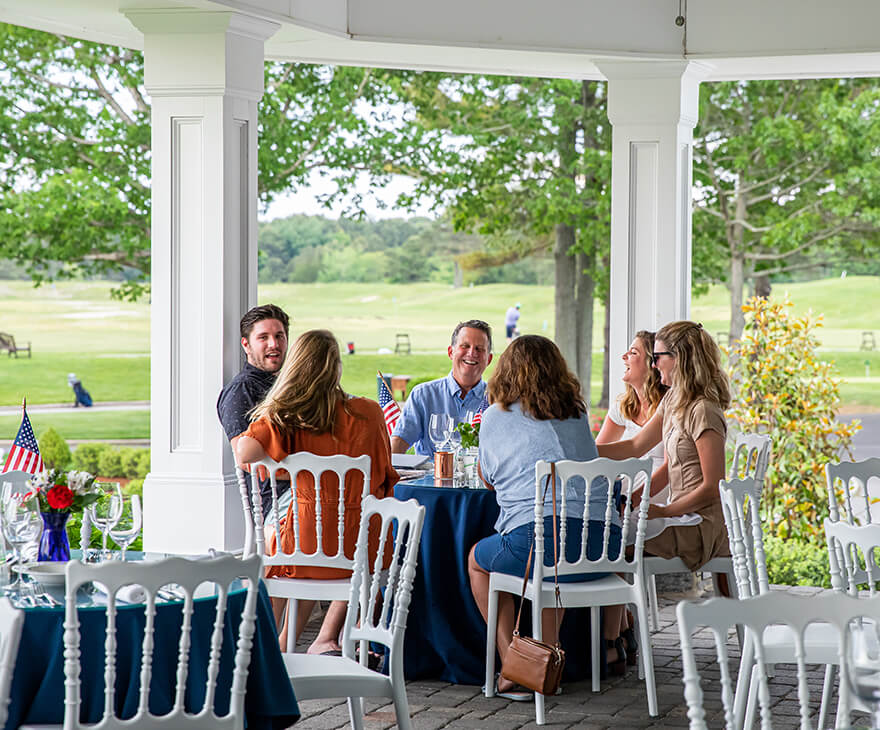 group enjoying a Memorial Day meal on the patio