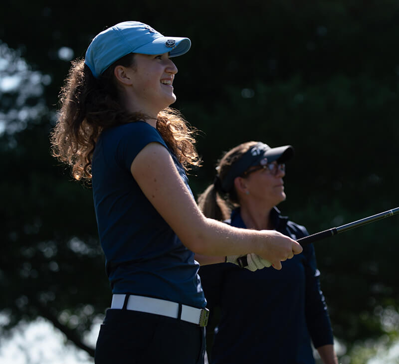 woman golfer watching her ball's flight